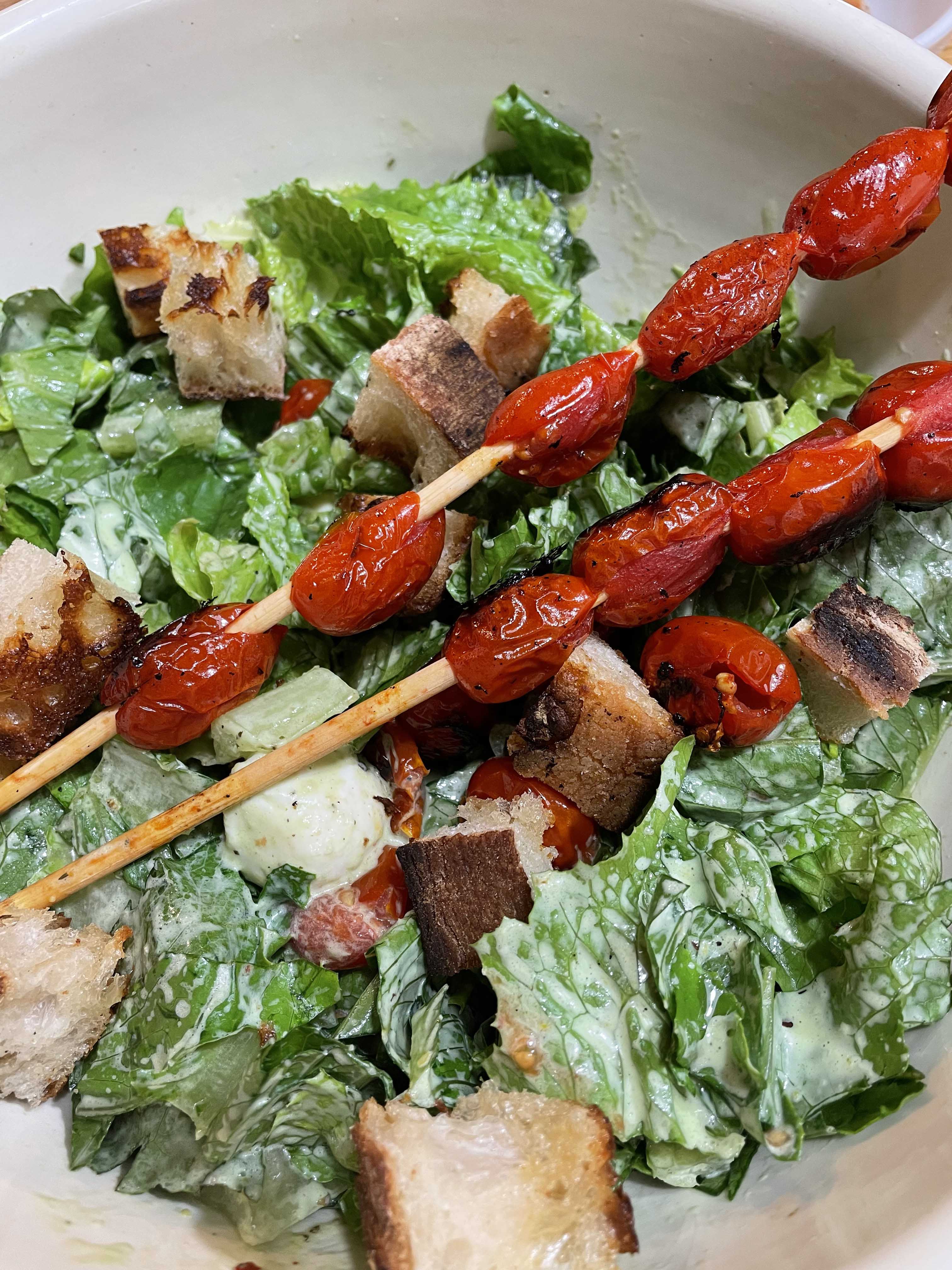 A bowl of salad with tomatoes